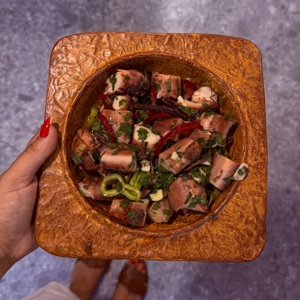 Meat and peppers in a clay dish